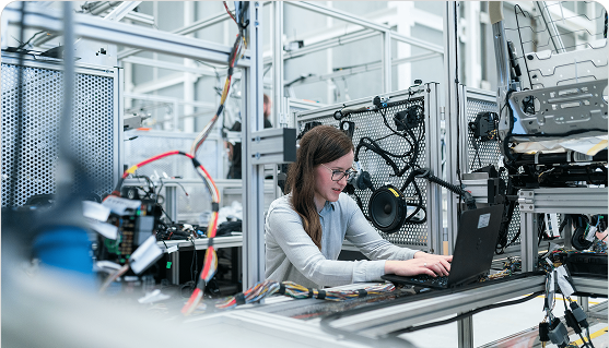 Woman engineer working on laptop in a lab