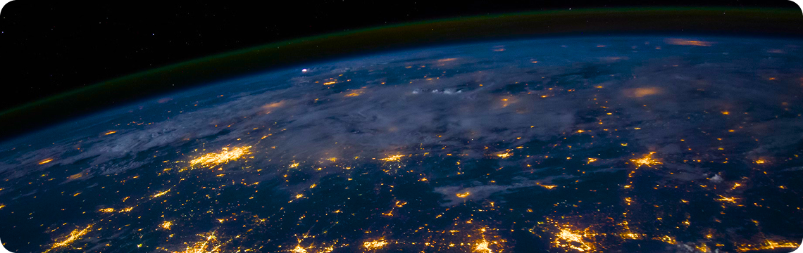 Earth from space at night, city lights glowing